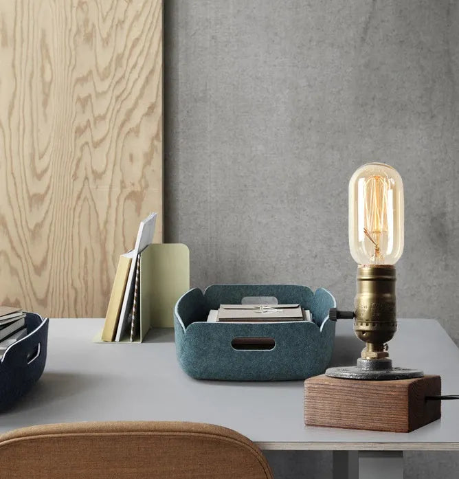 Small wood and iron water pipe style table lamp on a table