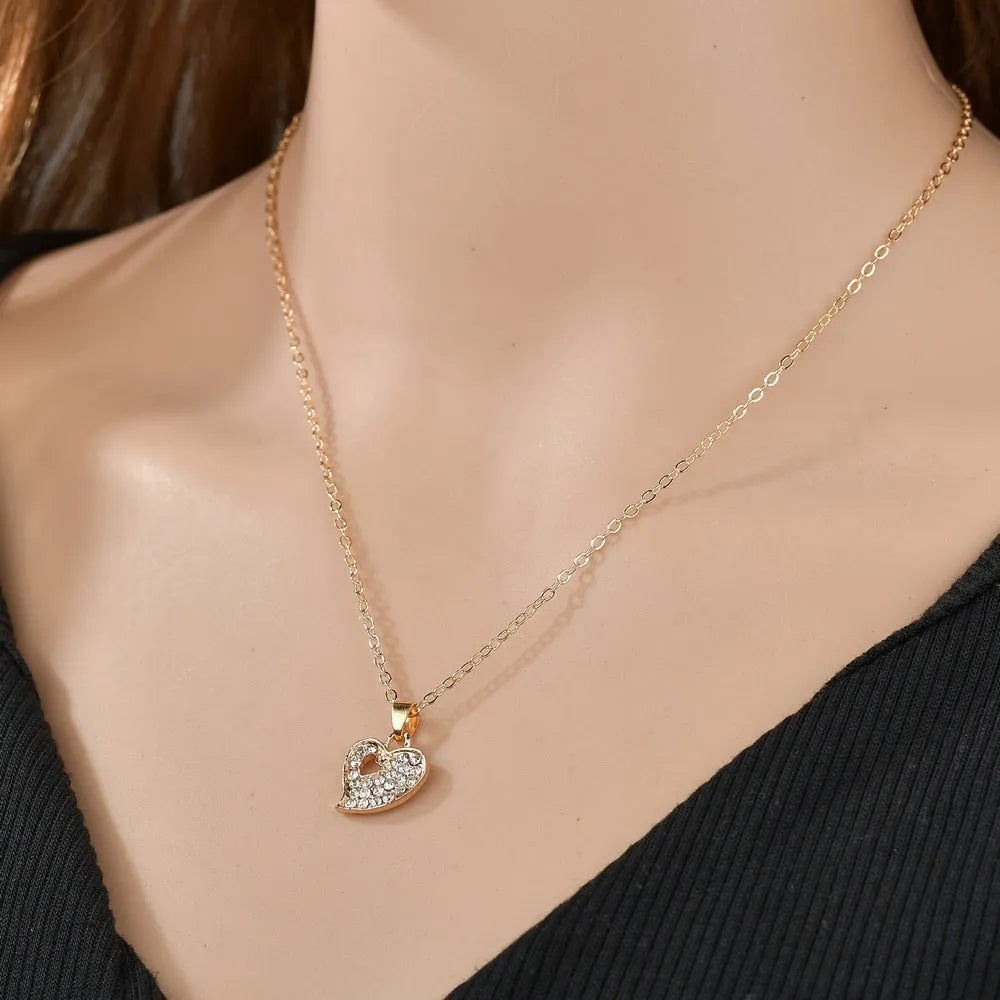 Gold electroplated alloy women's jewellery set with earrings, love and bell pendant decorations