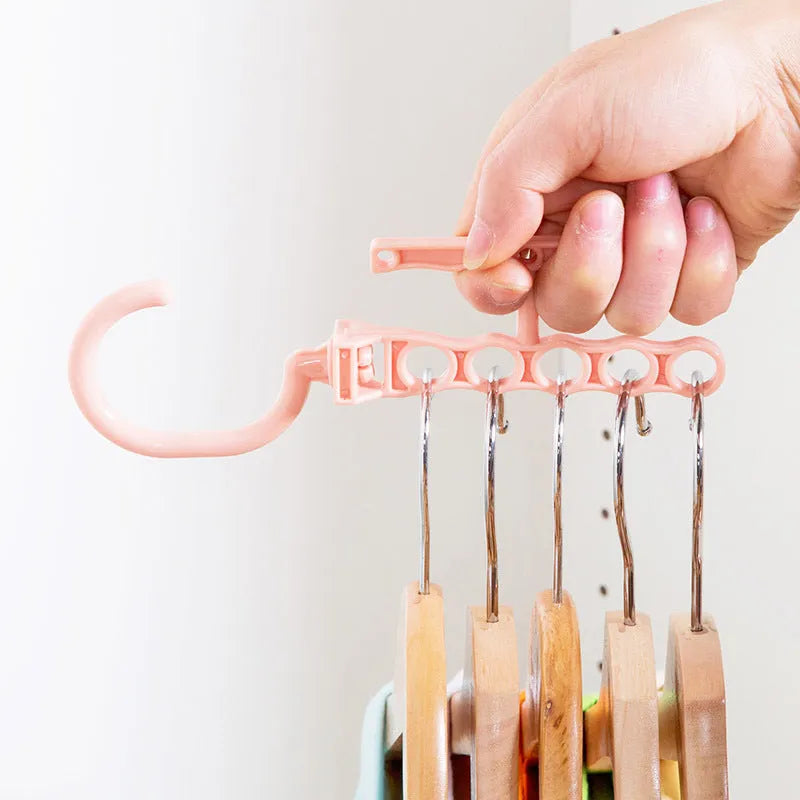 Magic wardrobe hanger with five holes and handle in blue, green, or pink colour options