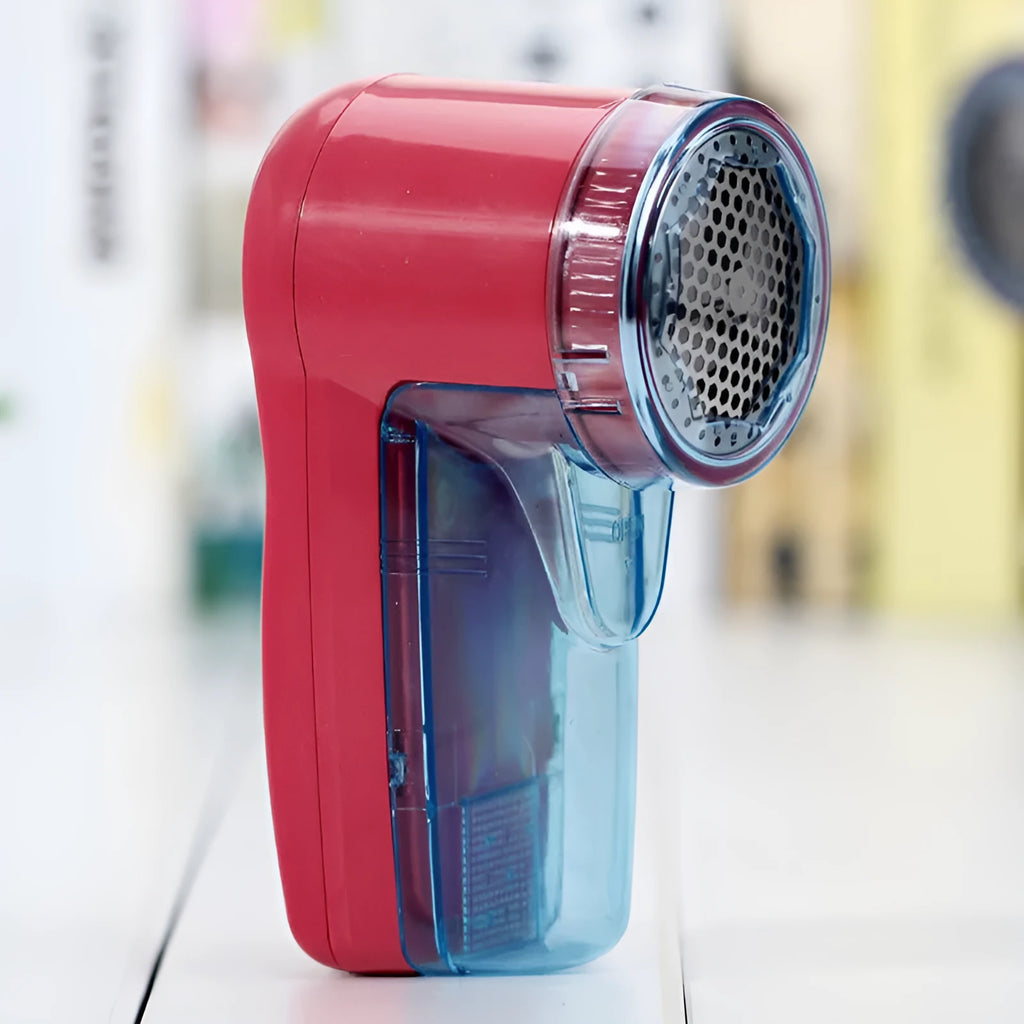 Portable electric clothing lint remover showing compact white body and shaving head