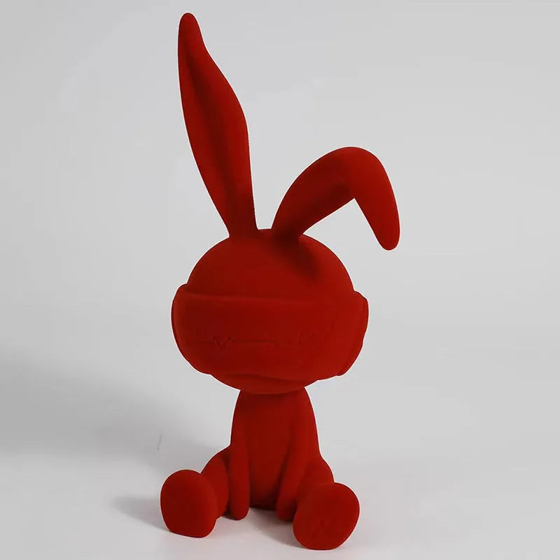 Resin rabbit ornament with suede blindfold in blue, green, or red colour options