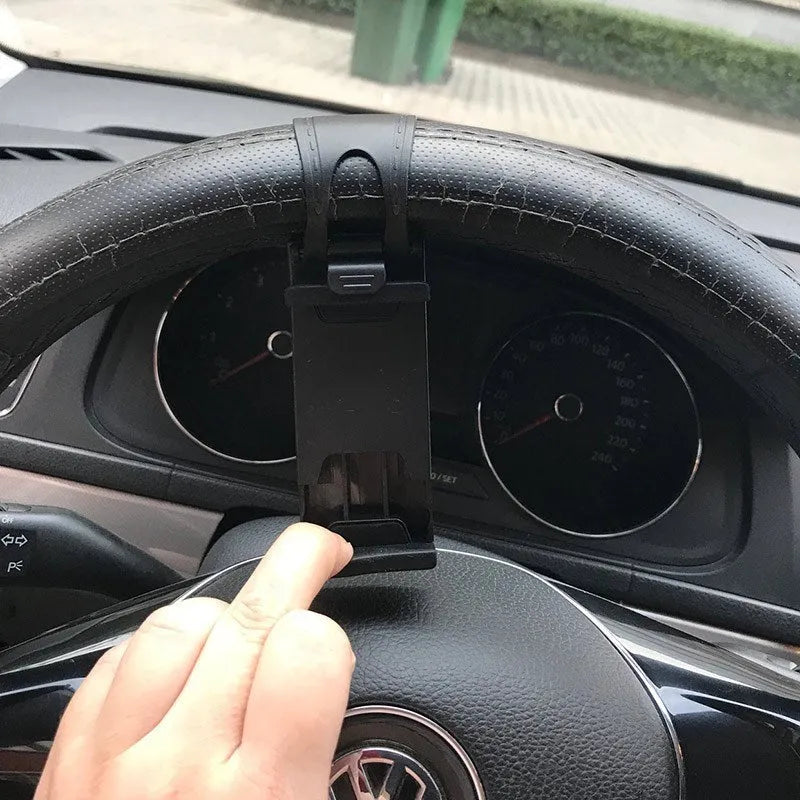 Black steering wheel phone clip holder mounted on car steering wheel