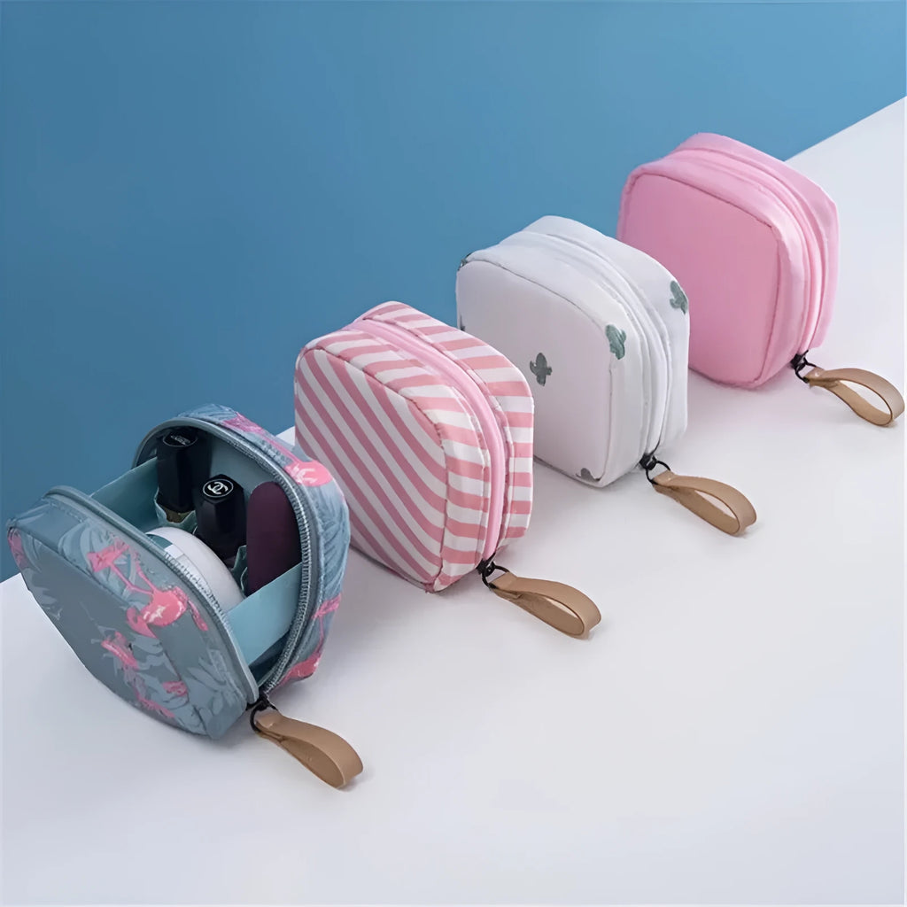 A plain blue cloth cube-shaped makeup storage bag on a table.