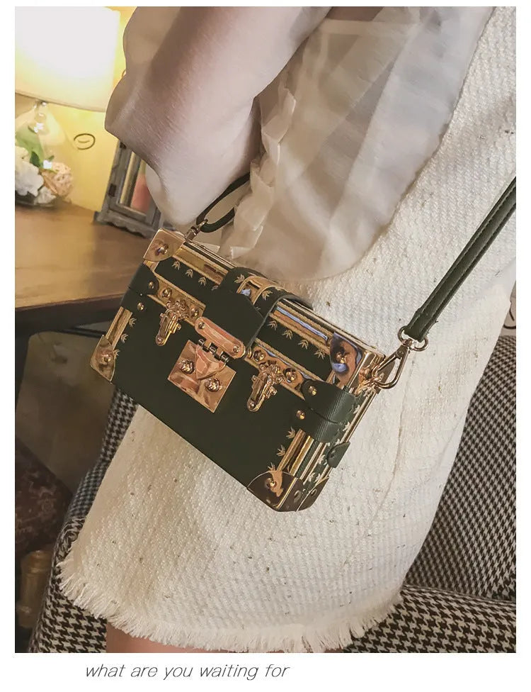 Hard-shell women's shoulder bag with single strap, flap closure, and decorative rivet details in black or green colour