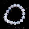 Natural blue moonstone round bead bracelet with white accents showing polished stone surface