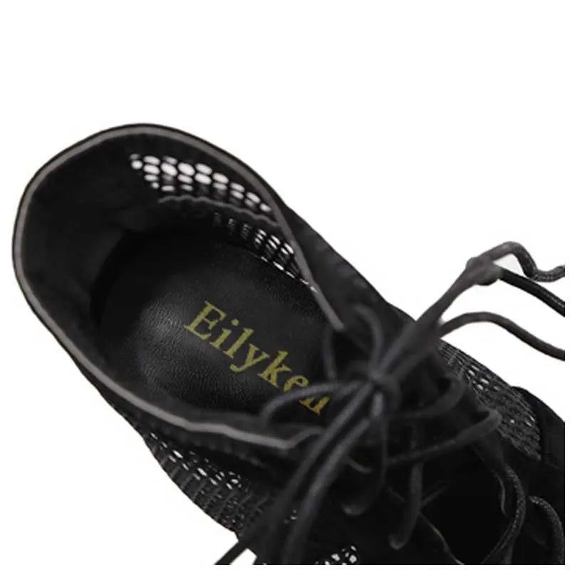 Black suede women's lace-up high heel shoes with 11.5 cm heels shown from side view