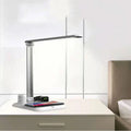 Black and white 4-in-1 multifunction LED desk lamp with wireless charging pad and USB port.