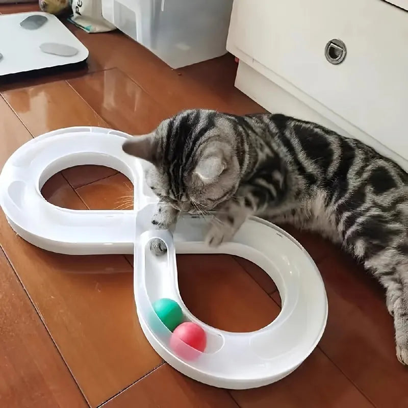 Blue and white cat toy set with a turntable track ball and a teasing stick on a floor.