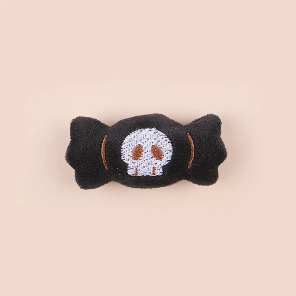 Plush cat teaser wand toy with colourful candy and skull designs on small attachment