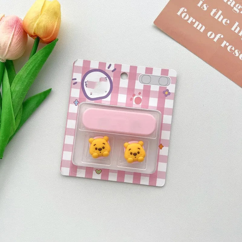 Colourful cartoon character plastic clip holding a magnetic charging cable on a desktop