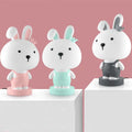 A plastic cartoon animal table lamp in a bear, cattle, rabbit, or tiger design with an LED light.