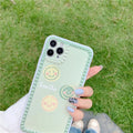 Green flexible TPU iPhone case with geometric smiley face and polka dot frame design.