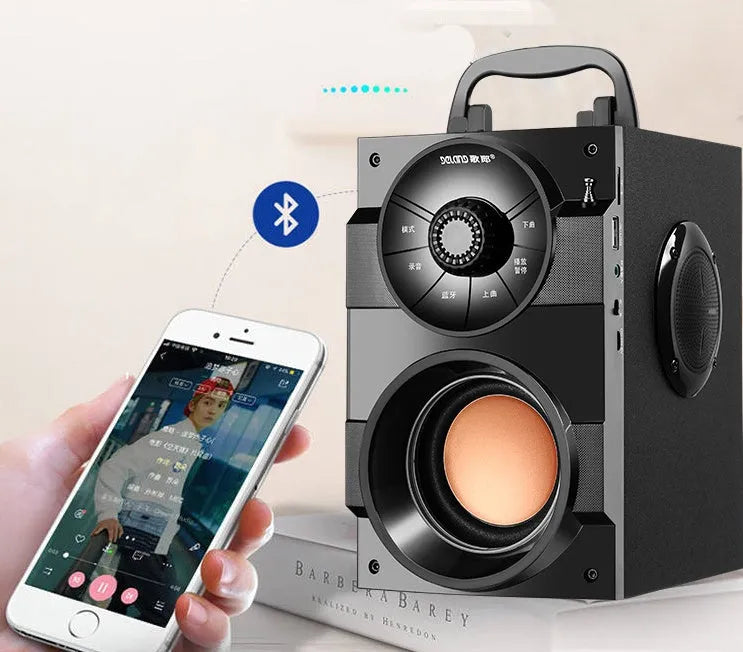 Black portable mini home audio system with subwoofer, 3.5mm audio cable, and USB charging cable.