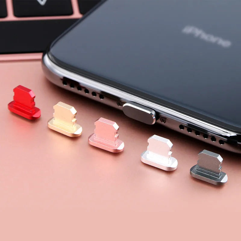 Aluminium alloy iPhone charging port dust plug in various colours on a white background.