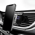 Black car phone holder clipped to a car air vent