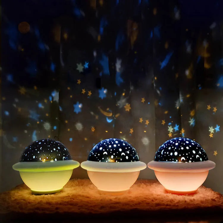 Green UFO-shaped night light projecting a starry sky pattern onto a surface, showing its modern plastic design.