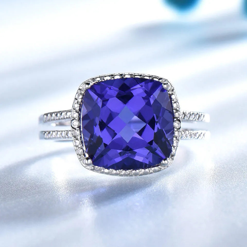 Blue Tanzanite gemstone sterling silver ring on white background showing band detail