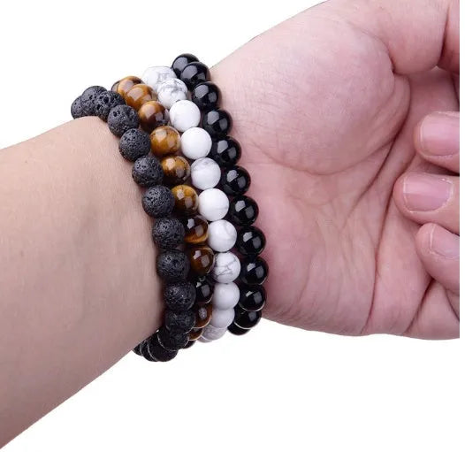 Black agate stretch bracelet with 8mm geometric beads on a black elastic cord.