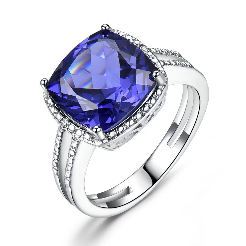 Blue Tanzanite gemstone sterling silver ring on white background showing band detail