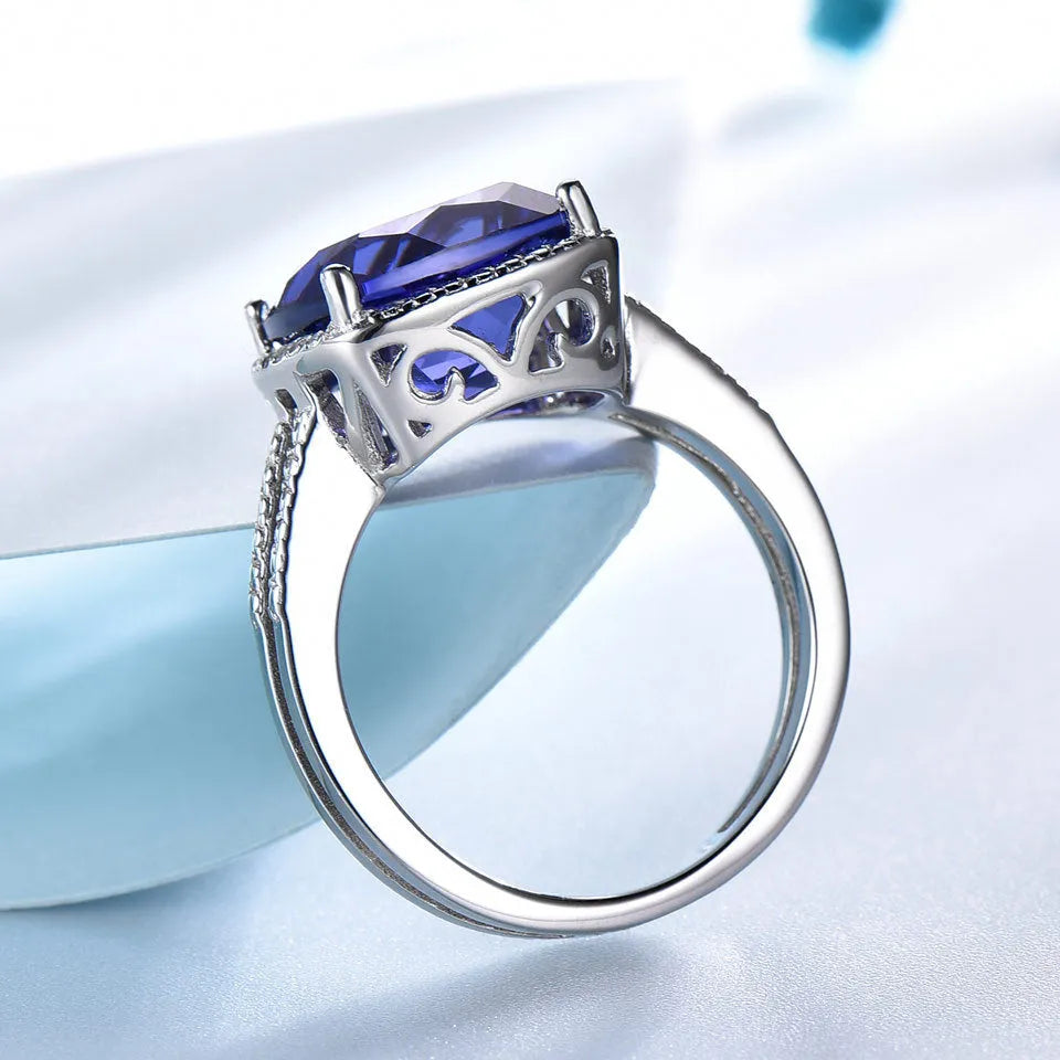 Blue Tanzanite gemstone sterling silver ring on white background showing band detail