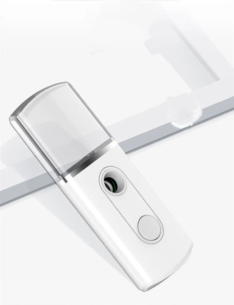 Portable facial nano mist humidifier in white, 10cm long, with 20ml water tank and USB cable