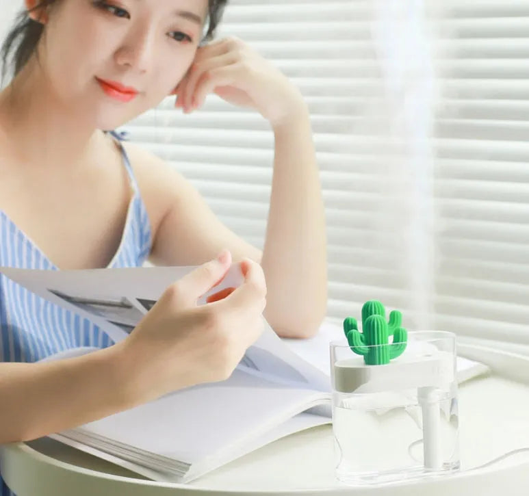 Transparent green cactus USB portable humidifier on desk showing water level inside plastic body