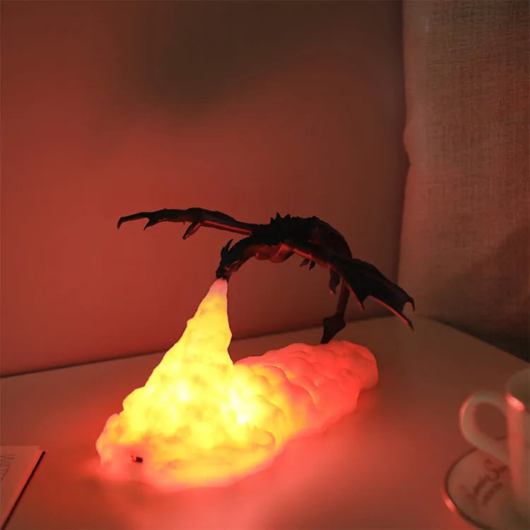 3D printed red dragon night light glowing on a table with USB cable
