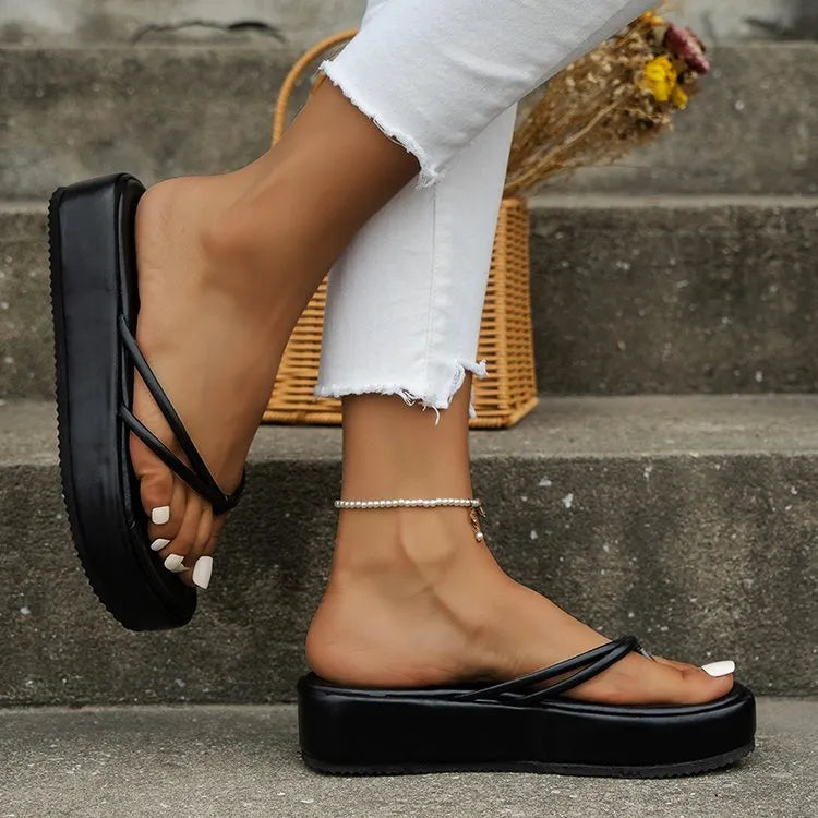 A pair of thick-soled casual flip-flops in a chosen colour, showing the round toe and herringbone patterned footbed.