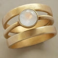 Gold geometric ring with white chalcedony stone micro-inlaid in titanium steel band
