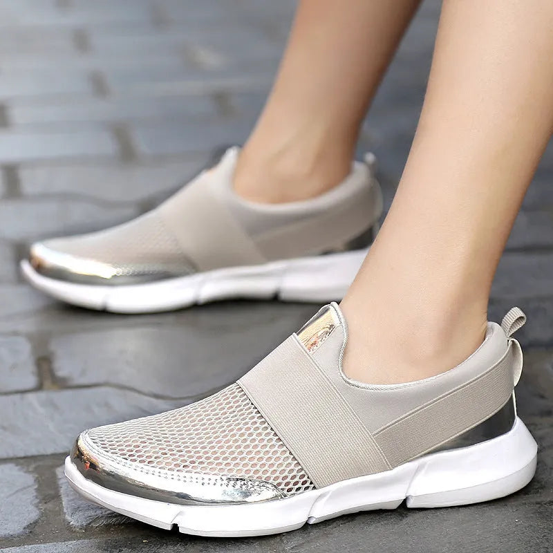 Women's blue breathable sneakers with mesh interior and low-top design on indoor surface