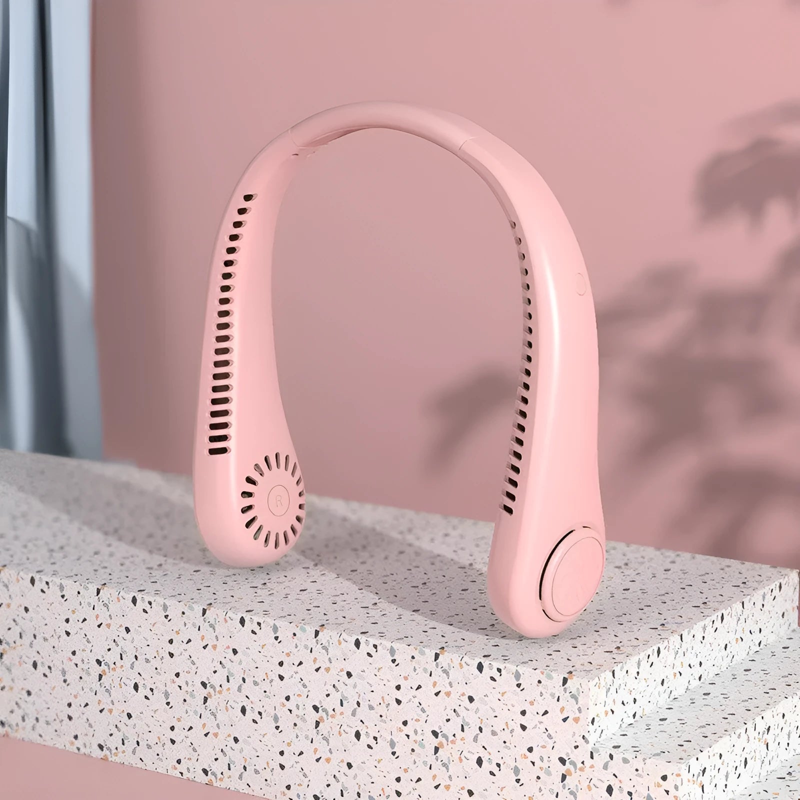 Pink USB rechargeable bladeless neck fan showing ergonomic neckband and compact design.