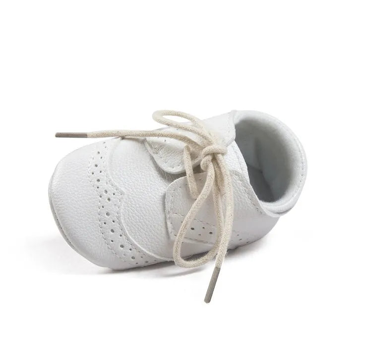 Vintage style baby shoes with soft soles in black synthetic leather