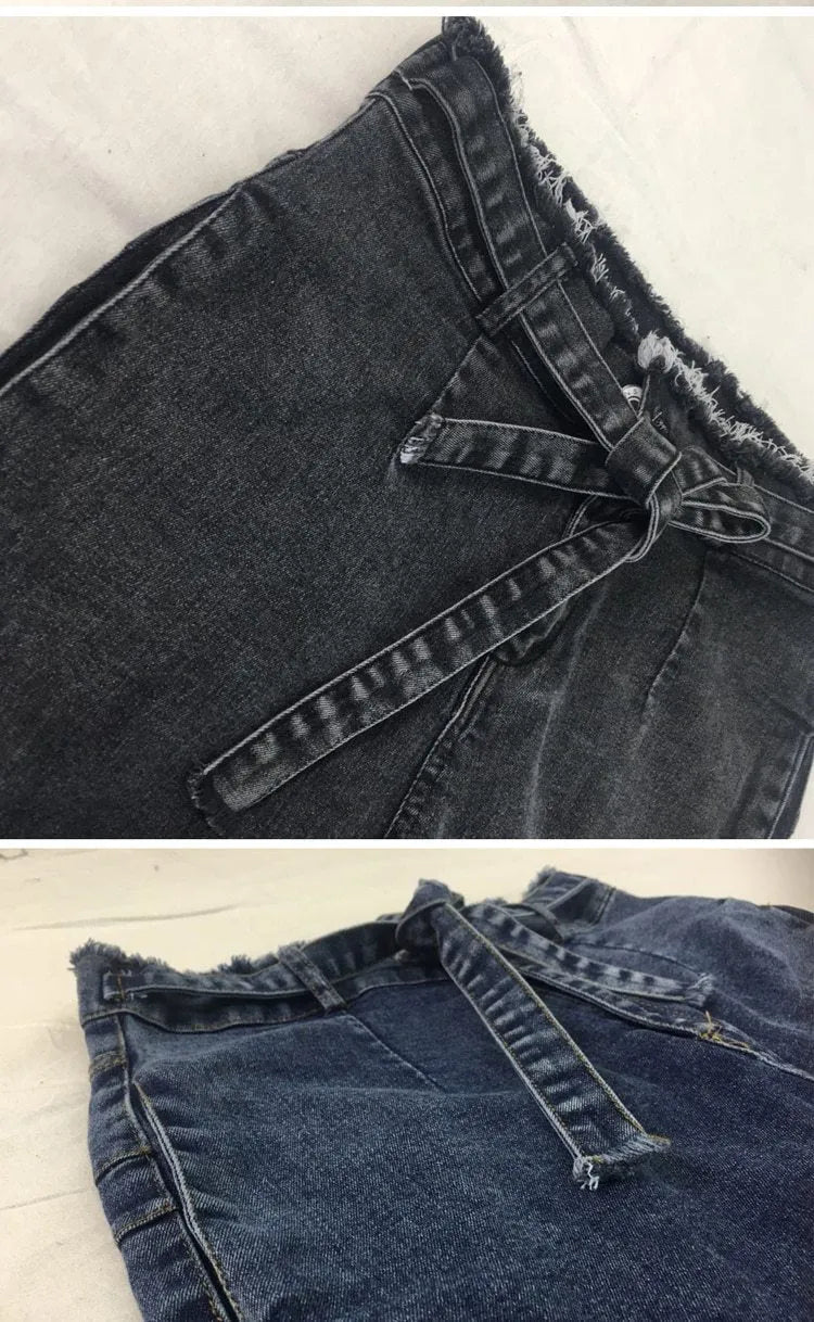 Woman wearing grey fringed straight leg jeans made from cowboy denim fabric.