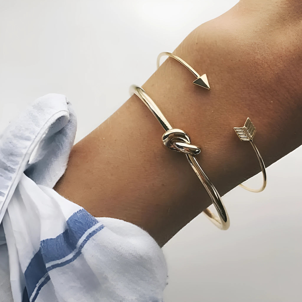 Gold vintage cuff bracelet for women with an arrow and knotted design detail.