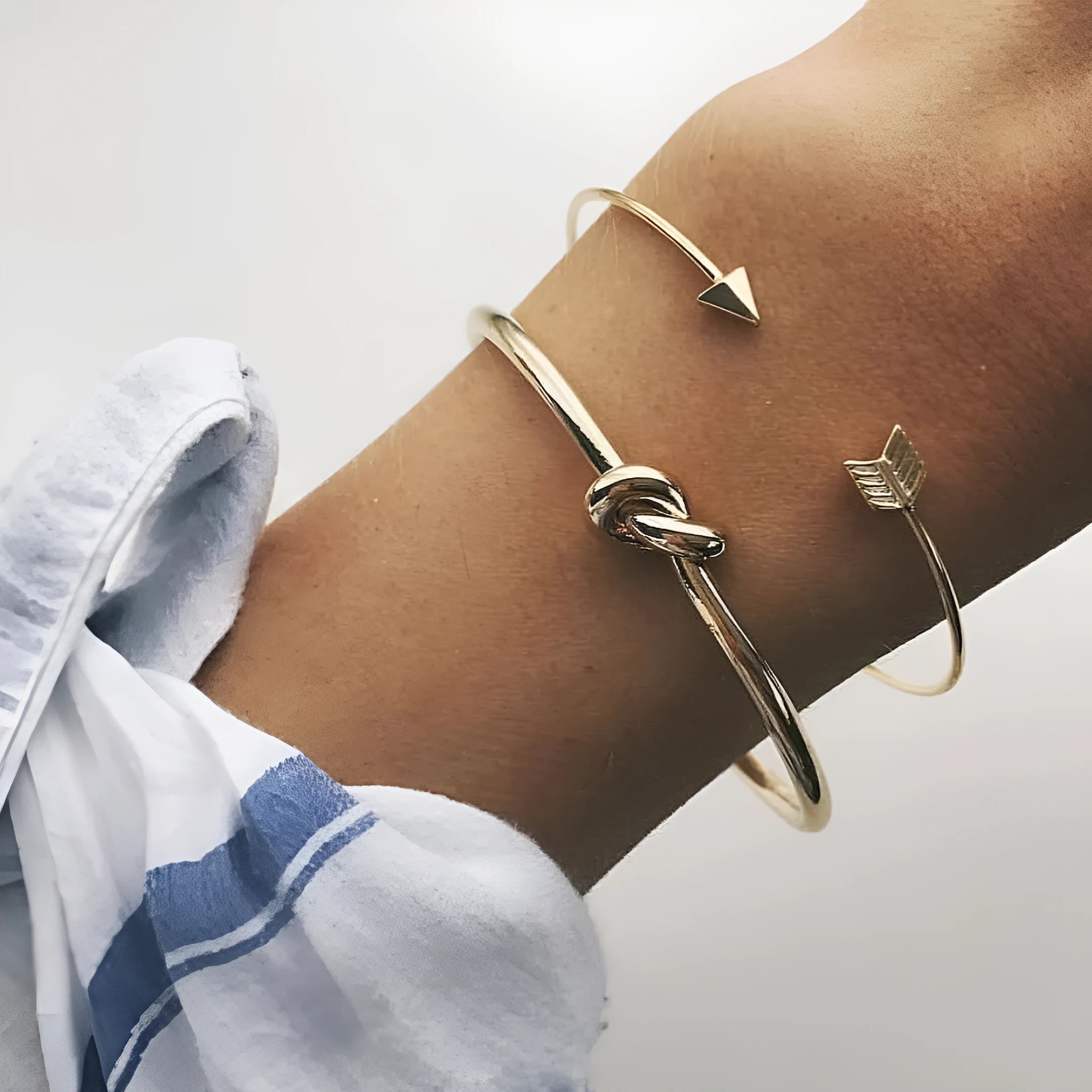 Gold vintage cuff bracelet for women with an arrow and knotted design detail.