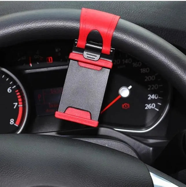 Black steering wheel phone clip holder mounted on car steering wheel