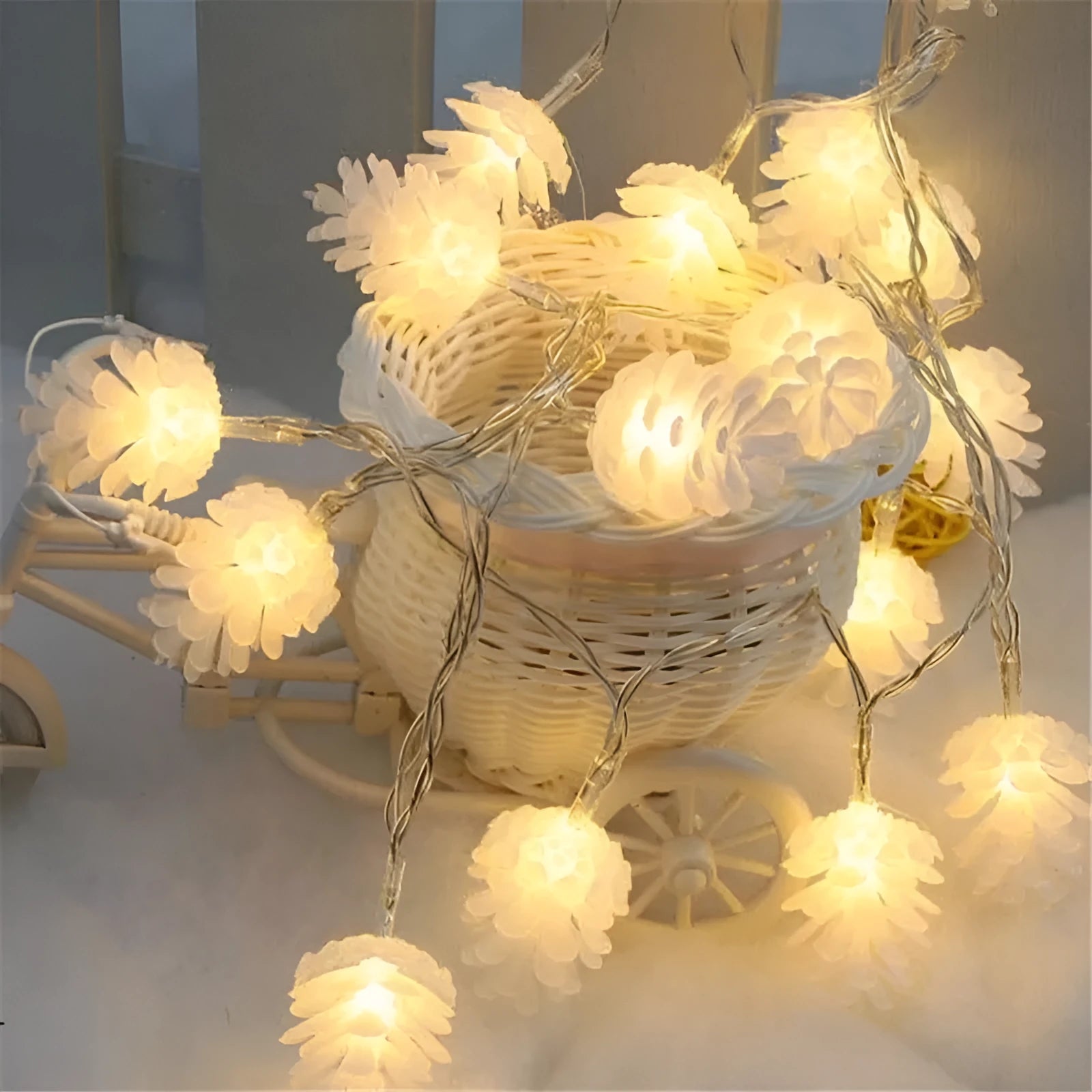 Warm white LED pine cone light string on a dark background, showing plastic shell details.