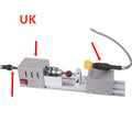 Silver metal mini woodworking lathe with carving knives on workbench