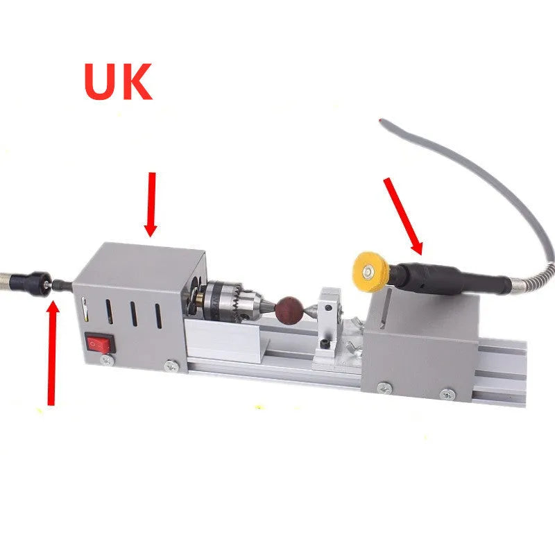 Silver metal mini woodworking lathe with carving knives on workbench