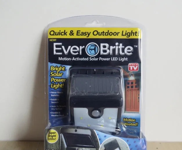 Pack of four white outdoor solar LED sensor lights for garden pathways.