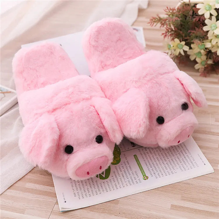 Pink pig floor slippers with plush lining shown on clean indoor surface