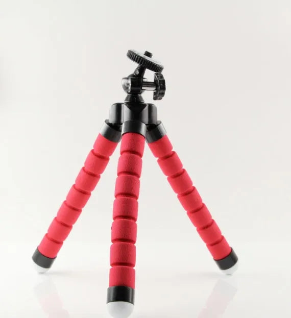 Black flexible octopus tripod with wrapped legs next to a smartphone