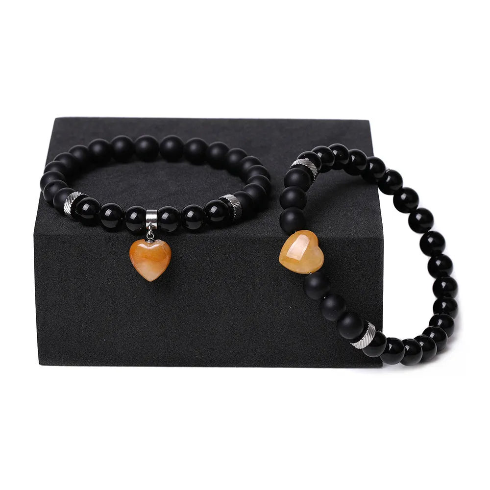 Set of two polished natural stone heart-shaped bracelets for couples in matching colour