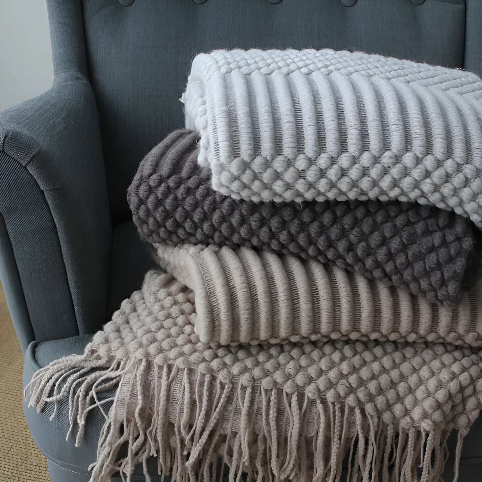Small polyester nap blanket in dark grey, khaki, or light grey measuring 127x170cm