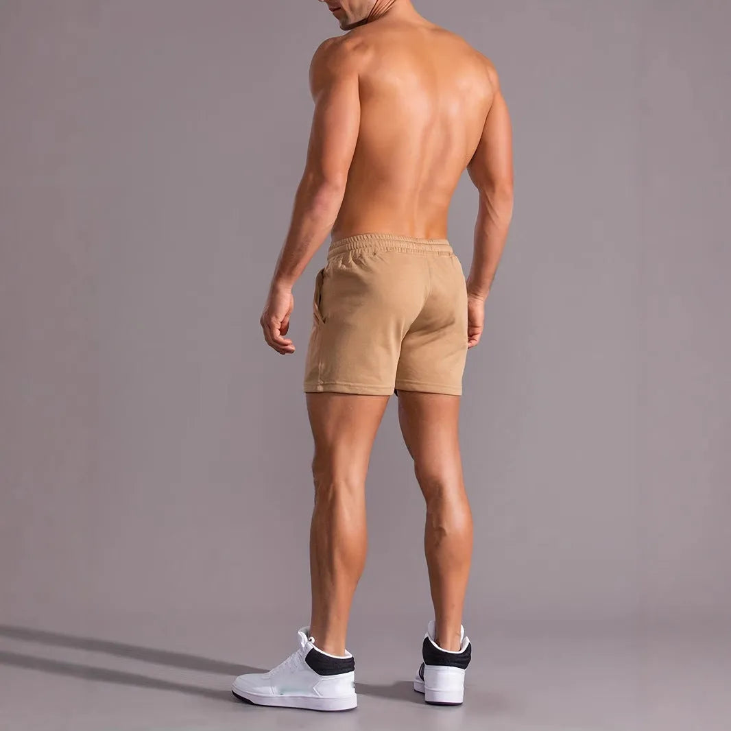 Men's casual khaki polyester sports shorts with coconut print on a model