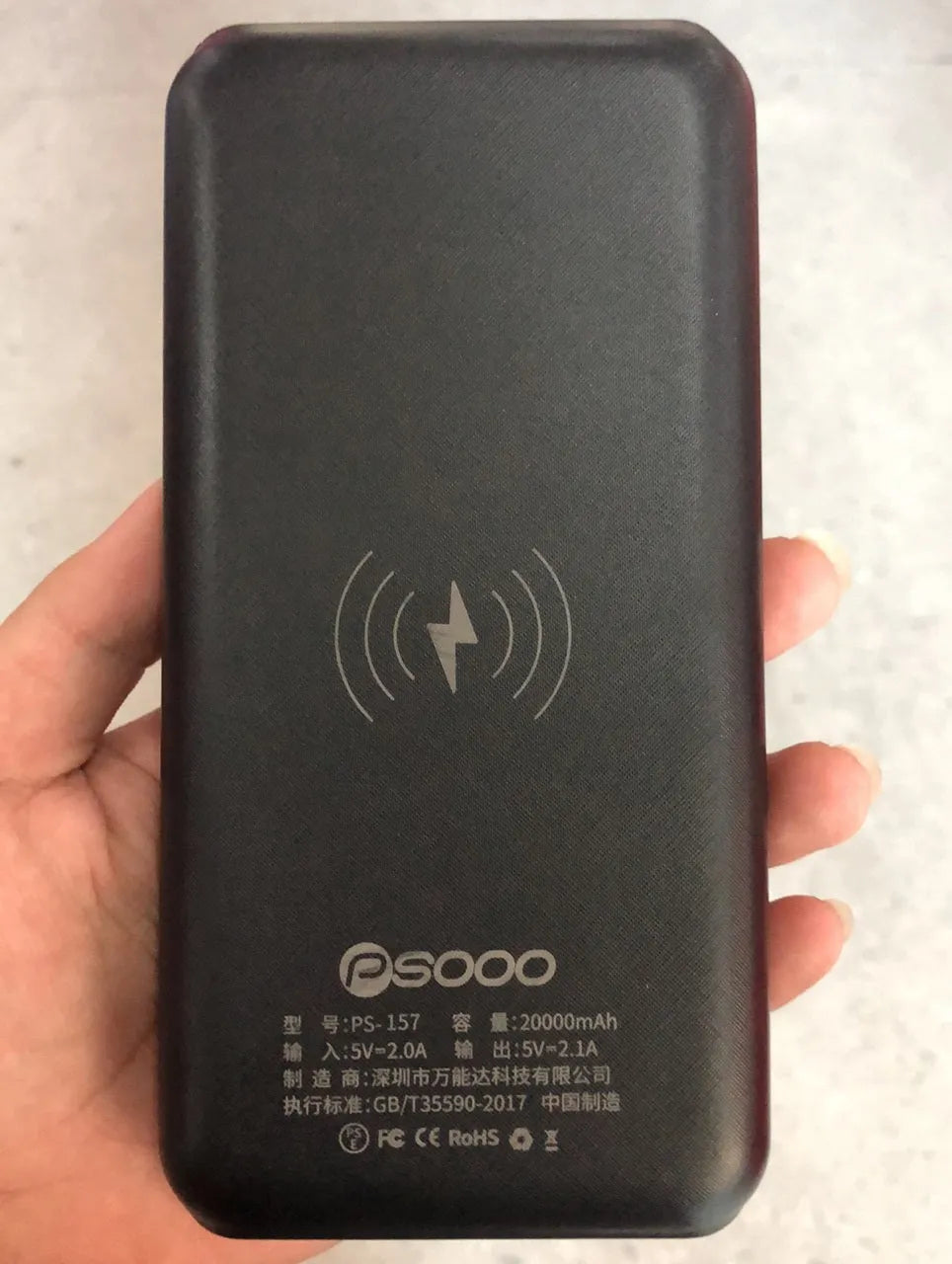 Qi wireless solar power bank with 3 USB outputs and LED flashlight in black plastic shell