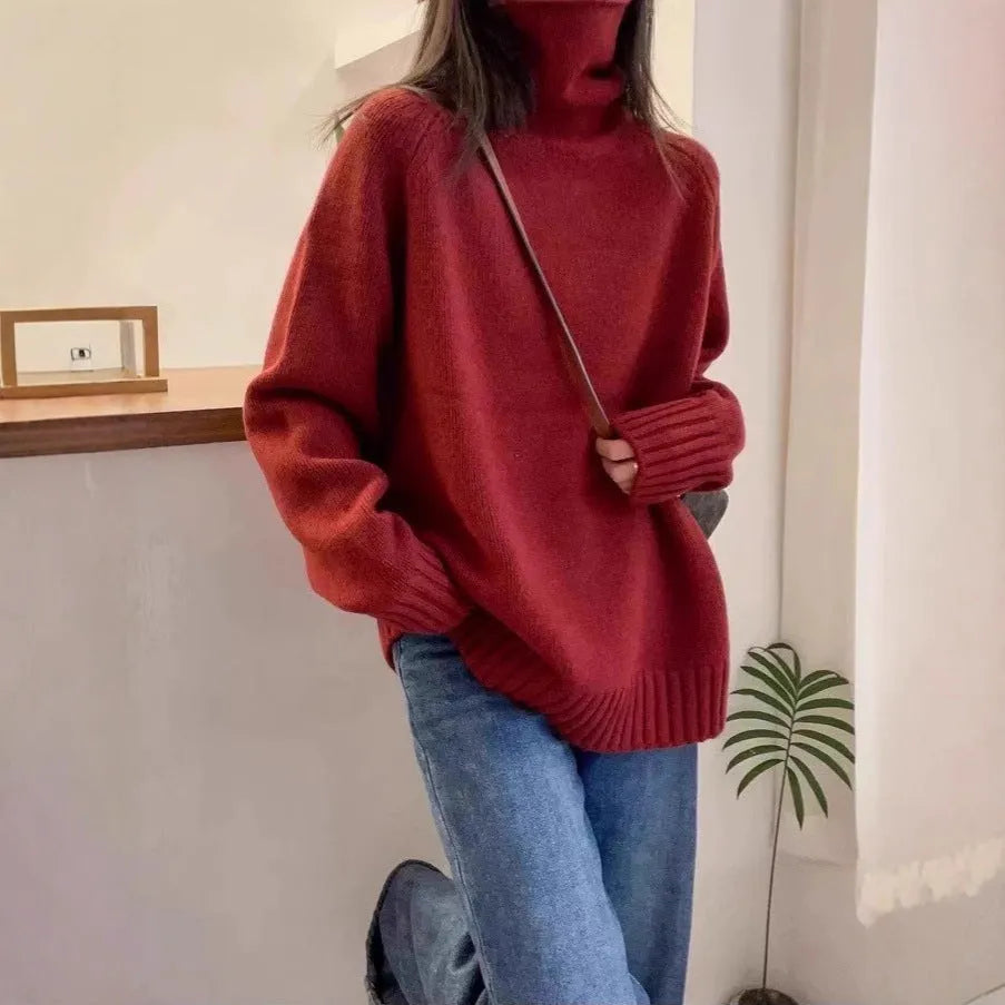 Women's loose grey turtleneck sweater with a thick knit and textured curling pile collar.
