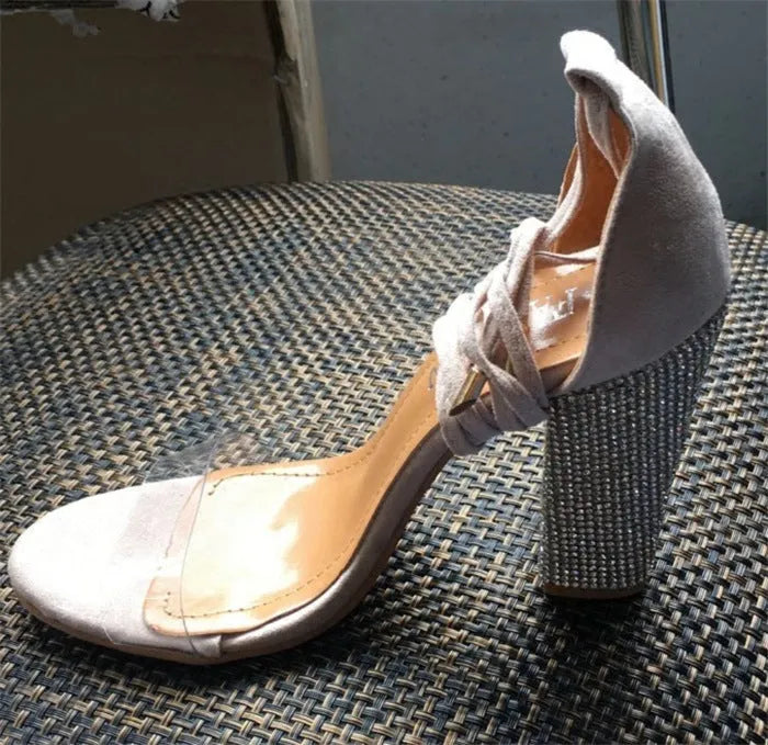 Black and gold women's pointed-toe high heel stiletto shoes on a white background.