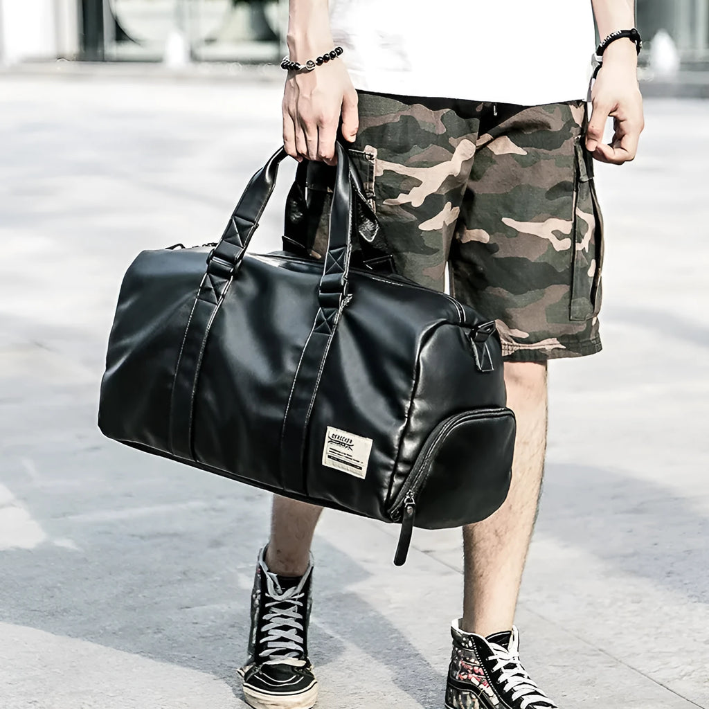 Large black PU leather sports training bag with multiple compartments showing laptop and camera pockets