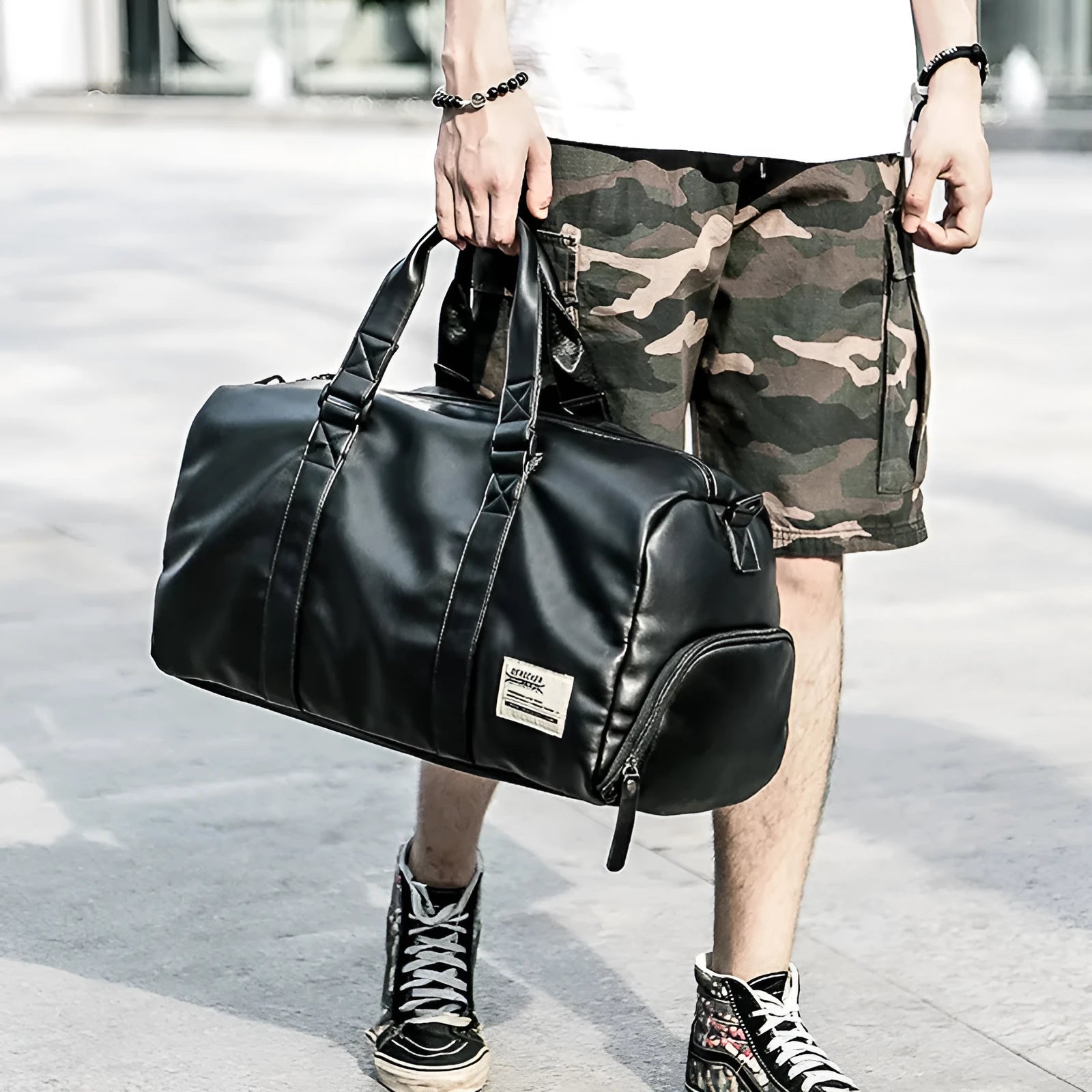 Large black PU leather sports training bag with multiple compartments showing laptop and camera pockets